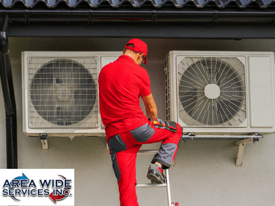 Man on the Ladder Repairing Outdoor AC
